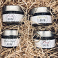 4 rubs per carni verdure e pesce in in barattolo di vetro con etichetta bianca e tappo argento in confezione di cartone aperta avvolti nella paglia